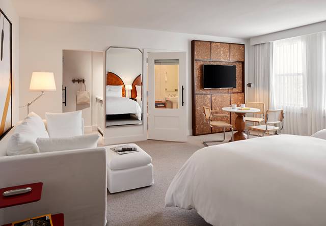 View of room with bathroom and kitchenette in queen hotel bedroom at Lyle DC.