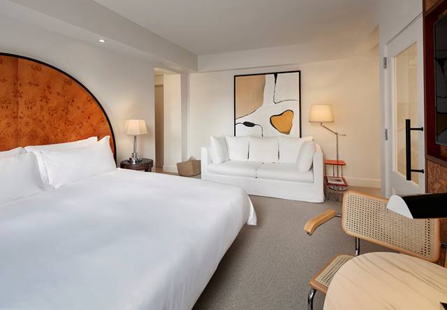 View of bed and sofa in Deluxe King with Kitchenette room at Lyle DC.