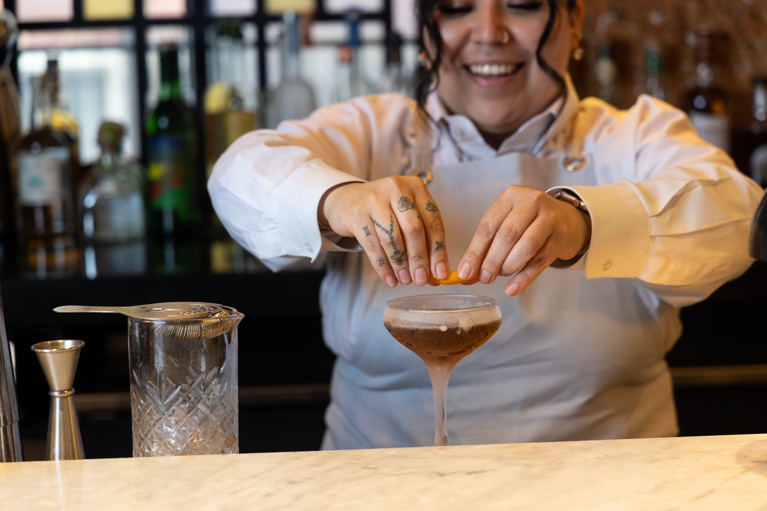 Bartender placing garnish on drink 