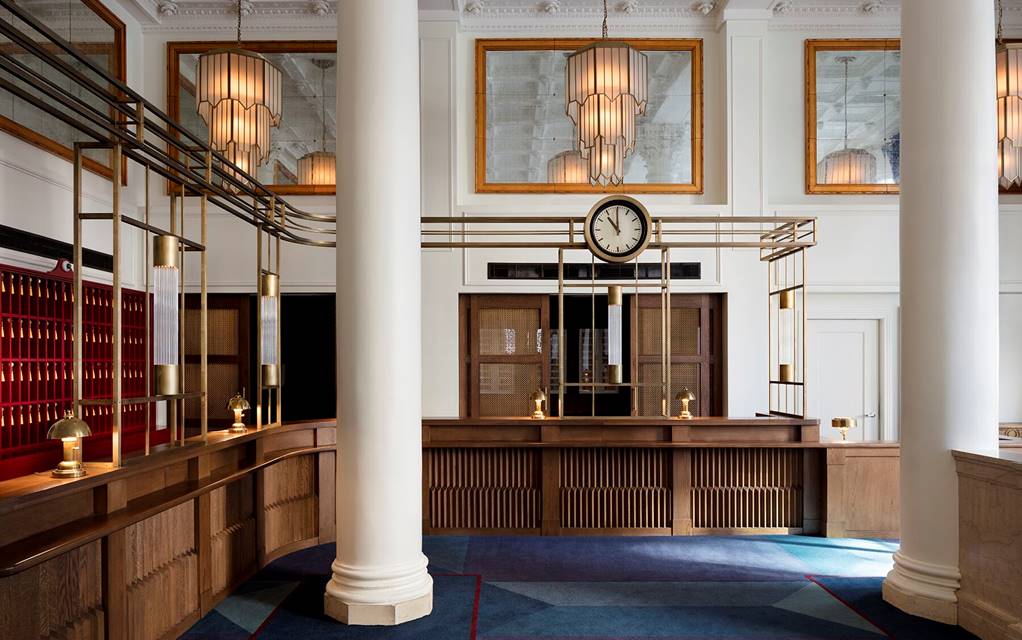 Wooden front desk with marble column at Riggs, Washington DC.
