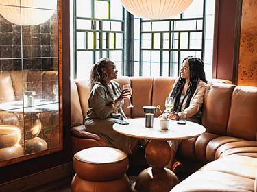 Two women drinking wine at Lyle's Restaurant and Bar
