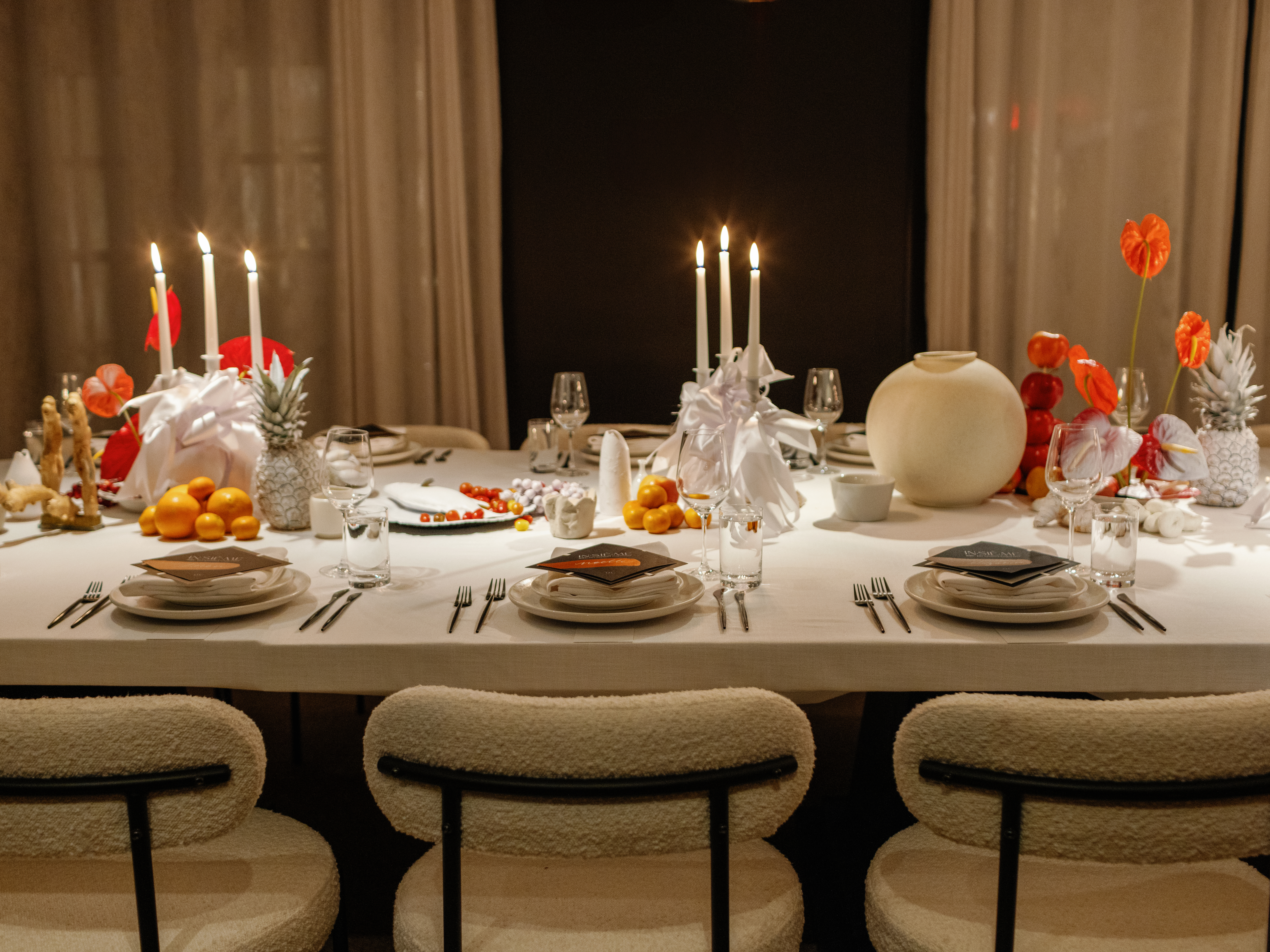 Beautiful table set up for a private dinner at Lyle DC hotel with natural colours, beige chairs, candles and orange flowers.