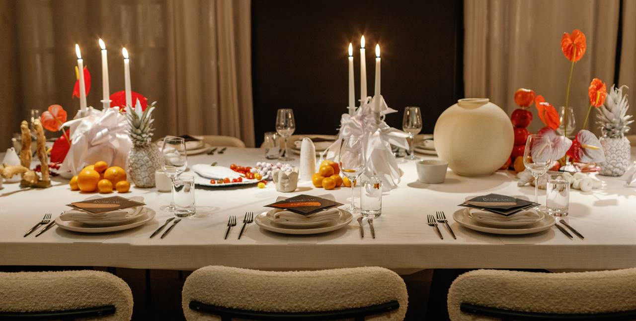 Beautiful table set up for a private dinner at Lyle DC hotel with natural colours, beige chairs, candles and orange flowers.