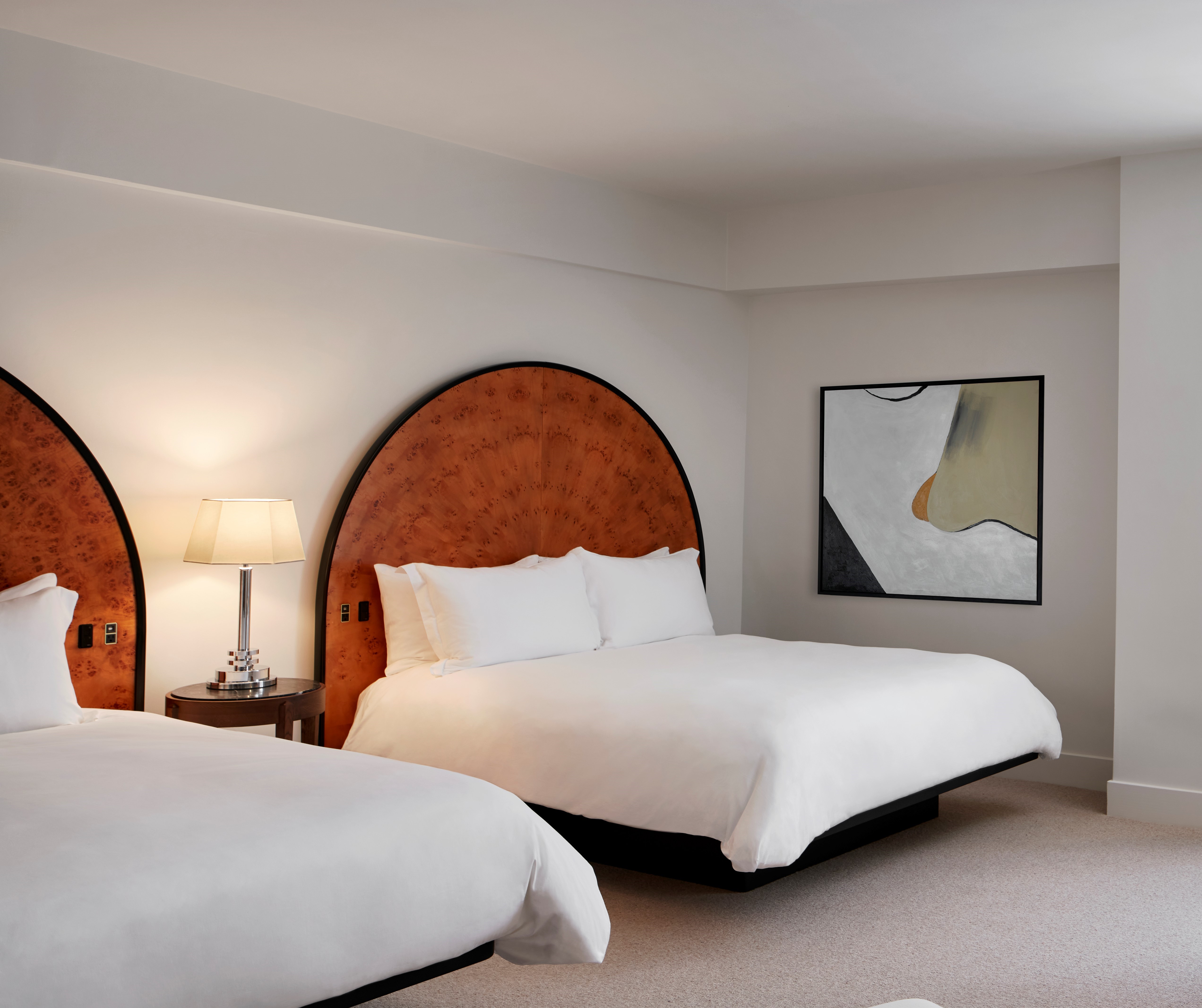 Deluxe Double Queen beds with art on wall 