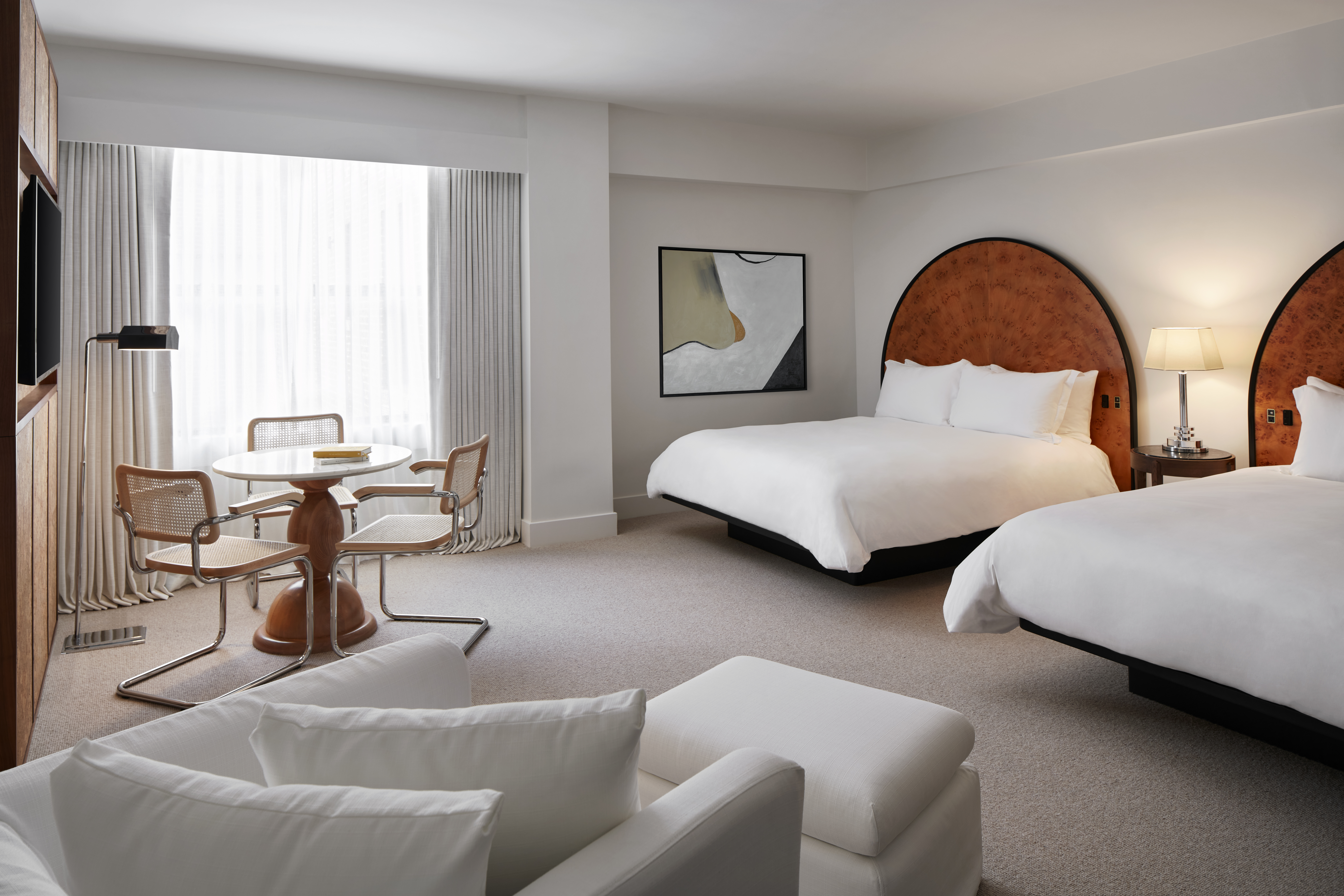 Bedroom with two beds and chaise at Lyle DC hotel.